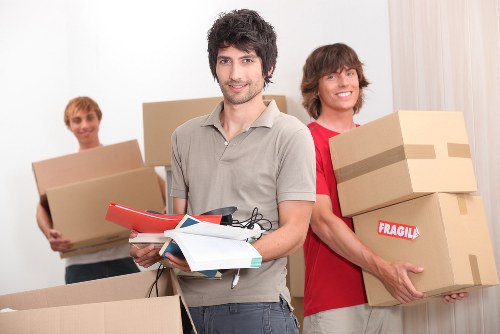 Small business equipment and furniture being loaded into a removals van