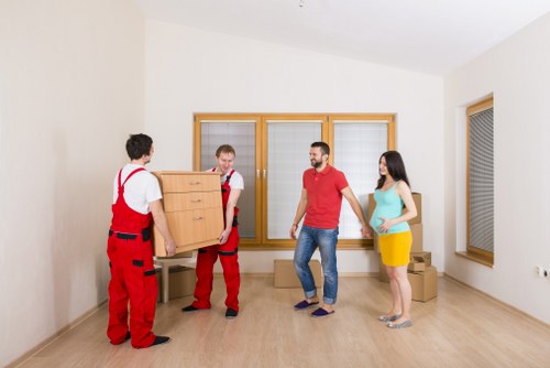 Moving team handling removals in a French city apartment building