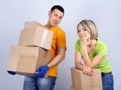 Professional movers handling furniture in a French home relocation