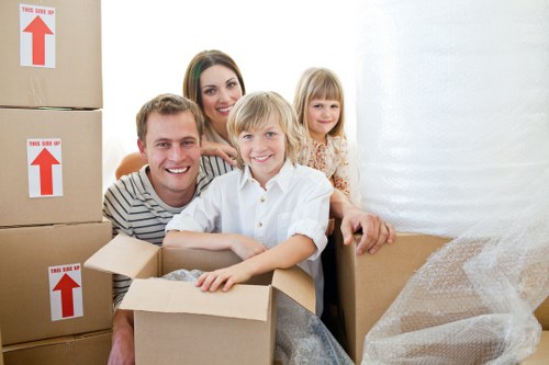Professional movers handling household furniture and boxes