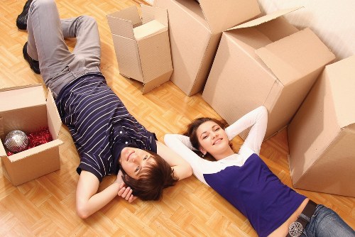 Removal team carrying boxes and household items